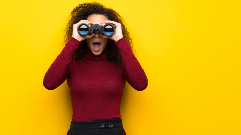 What to look for in African Fashion Shopping - Image of woman looking through pair of binoculars